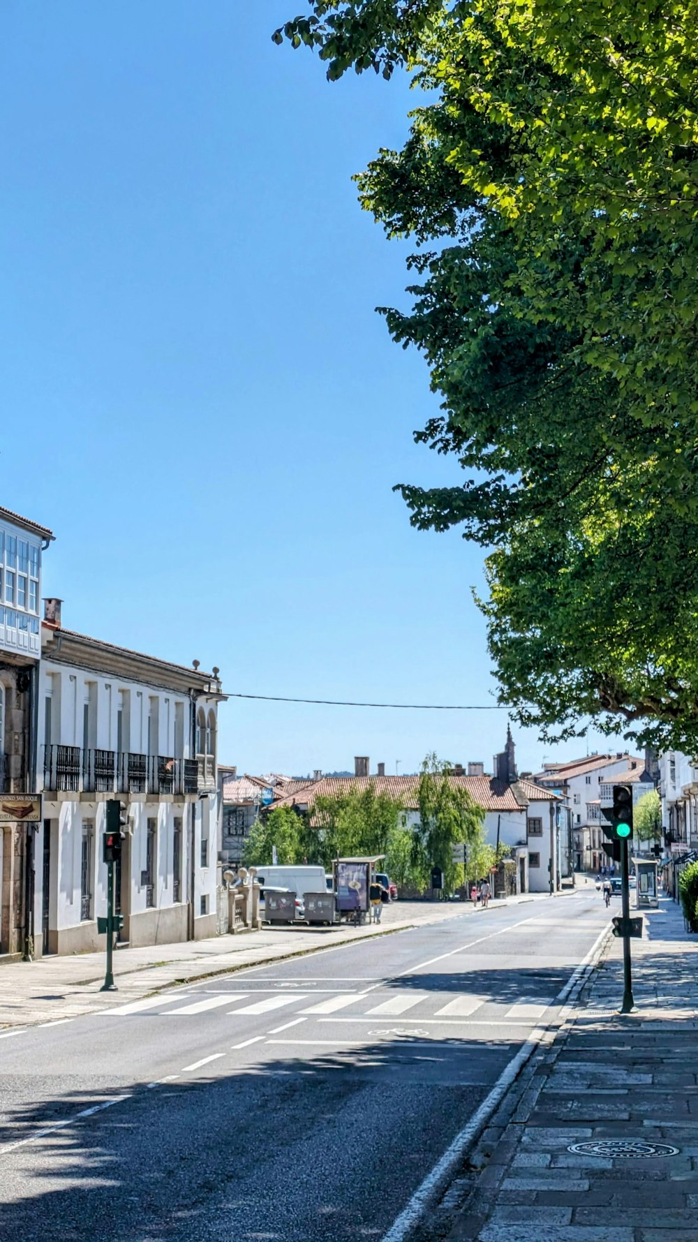 an empty street with a green traffic light