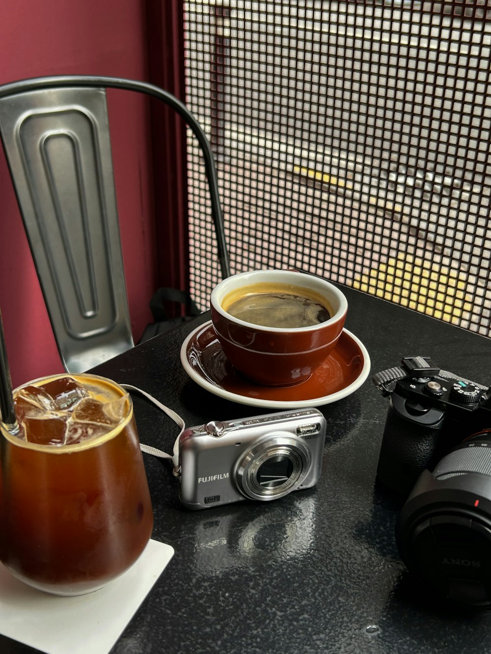 a camera and a cup of coffee on a table