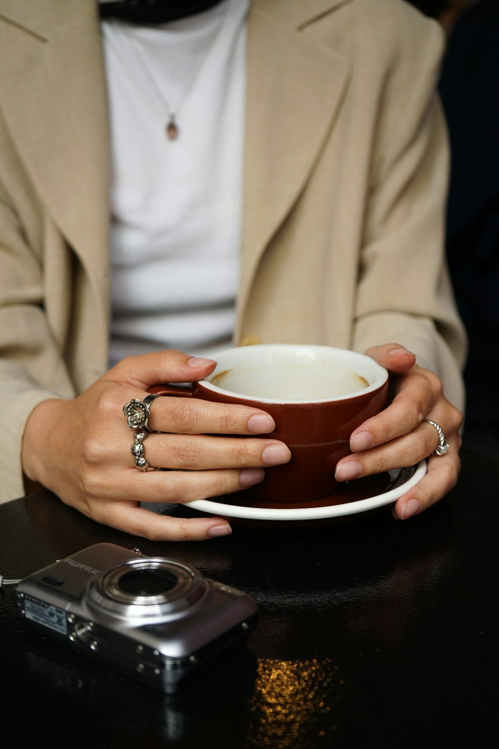 a woman holding a coffee cup in her hands