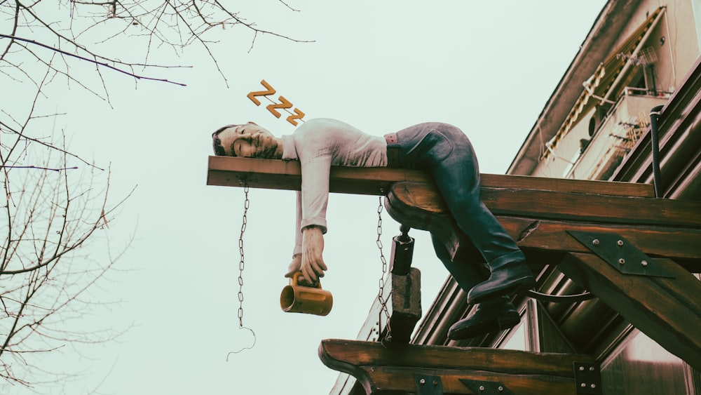 a man is hanging upside down on a building