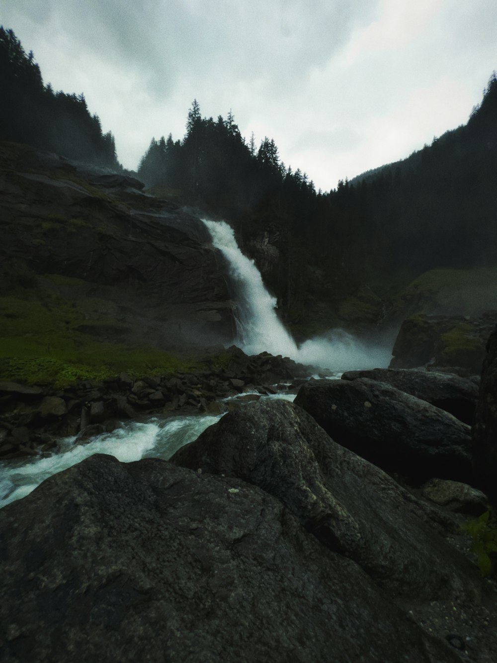 a waterfall in the middle of a rocky area