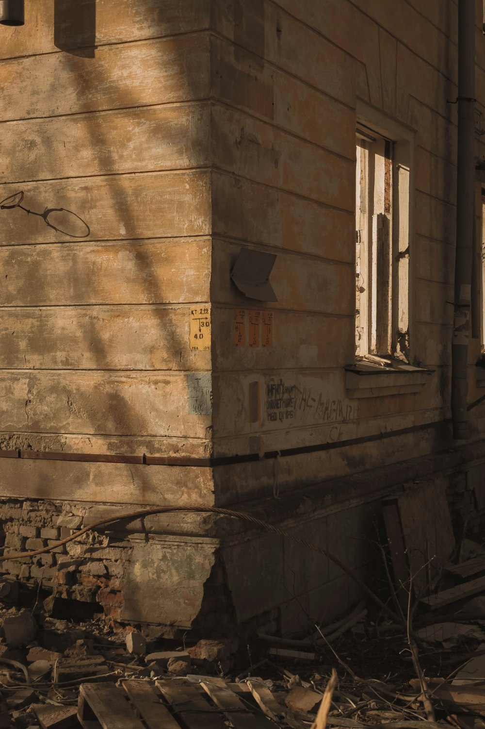 an old run down building with a broken window