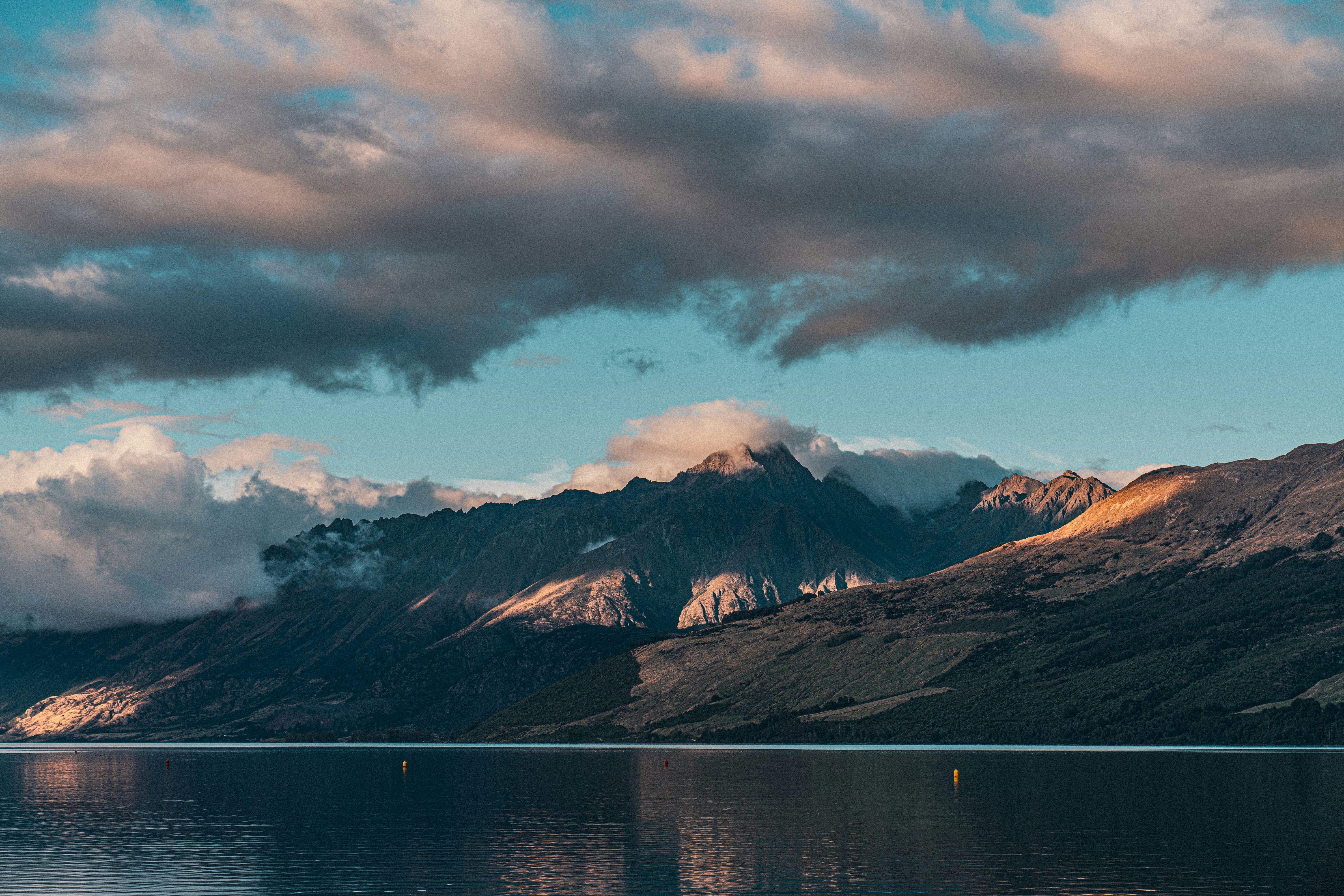 a large body of water with mountains in the background, 