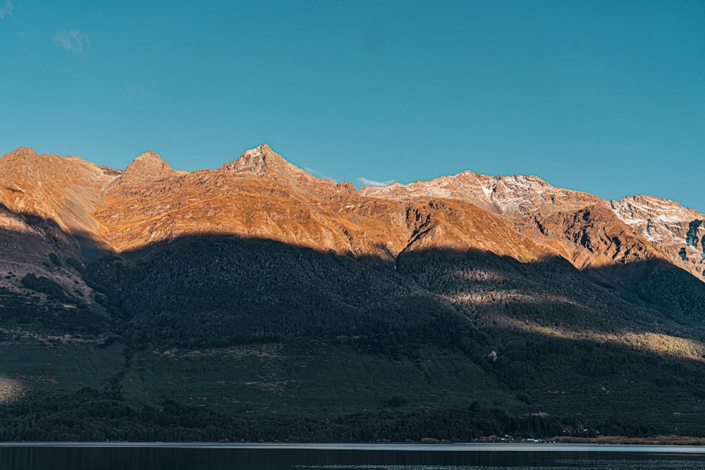 a mountain range with a body of water in front of it