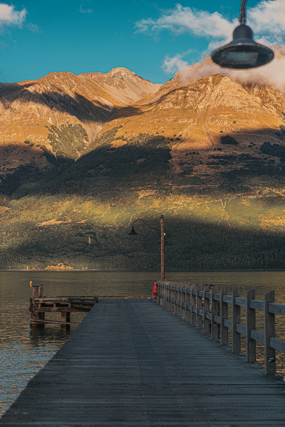 a pier with mountains in the background