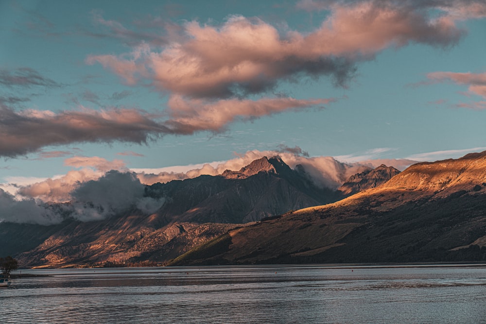 a large body of water with mountains in the background