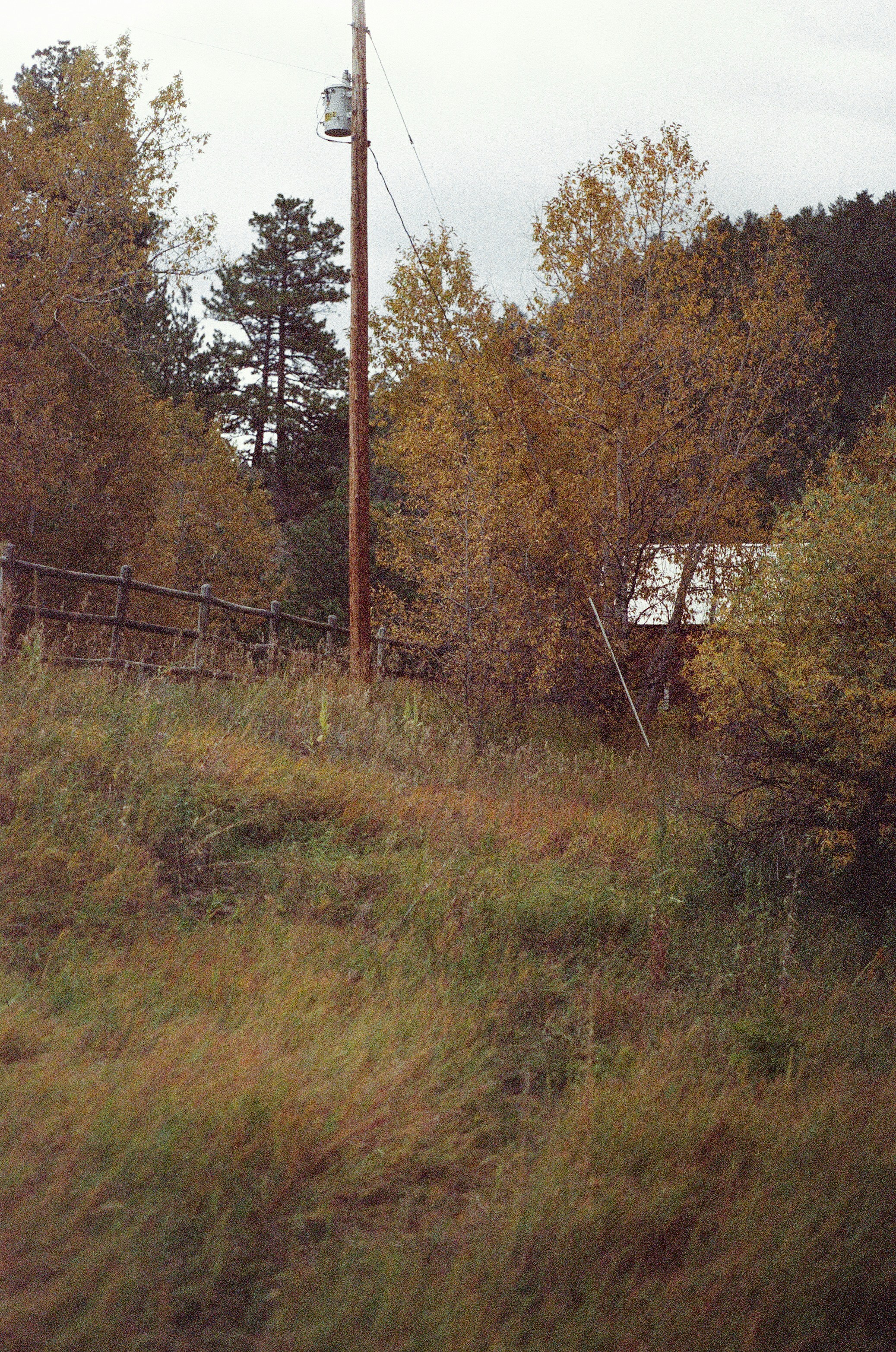 a wooden fence sitting on top of a lush green hillside