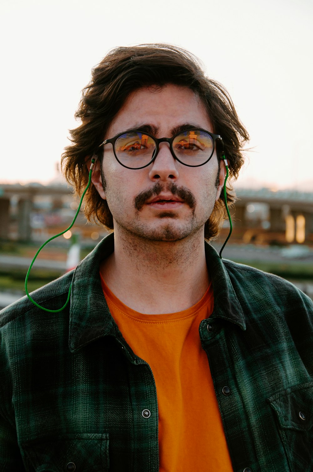 a man wearing glasses and a green shirt