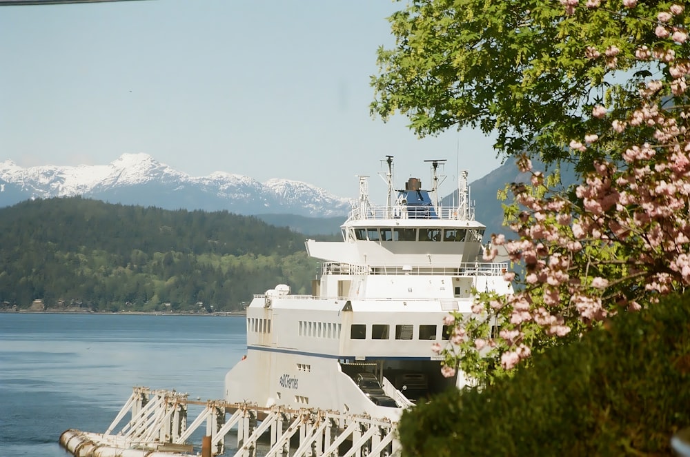 a large white boat sitting on top of a lake