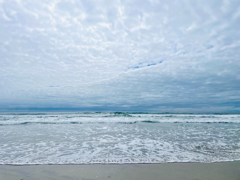 a beach with waves coming in to shore