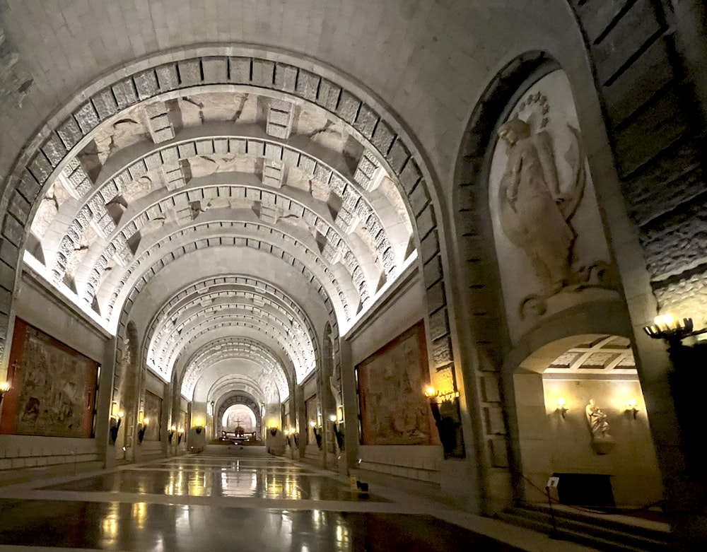 a long hallway with paintings on the walls