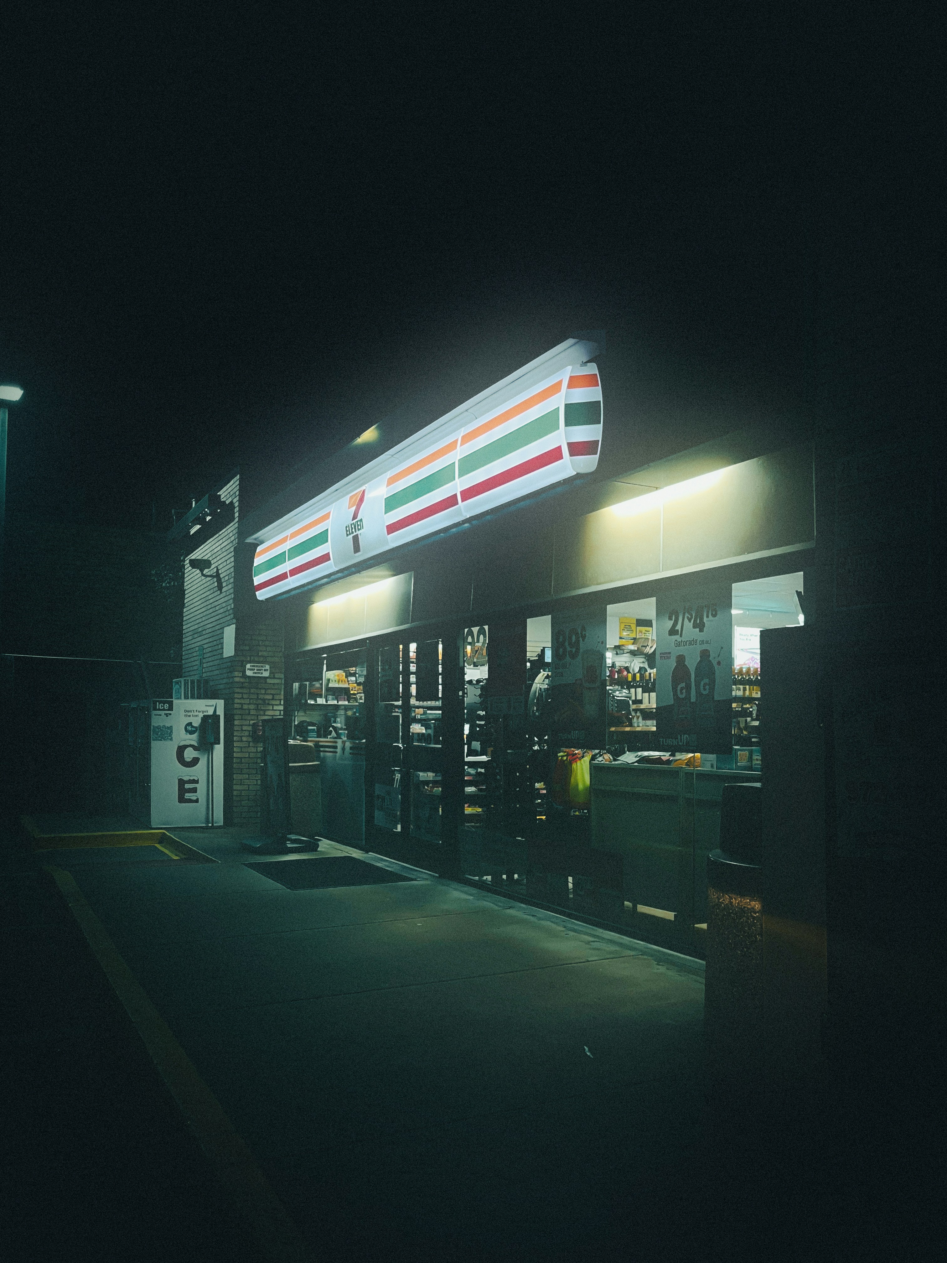 a gas station at night with the lights on