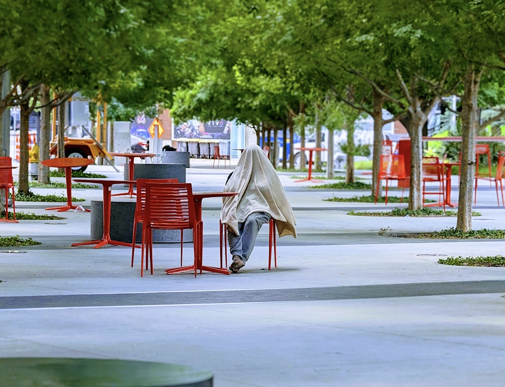 a person sitting at a table in a park