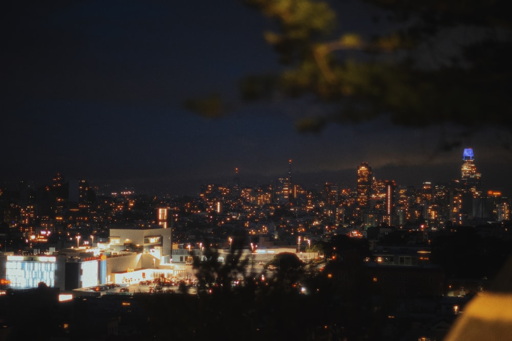 a view of a city at night from the top of a hill