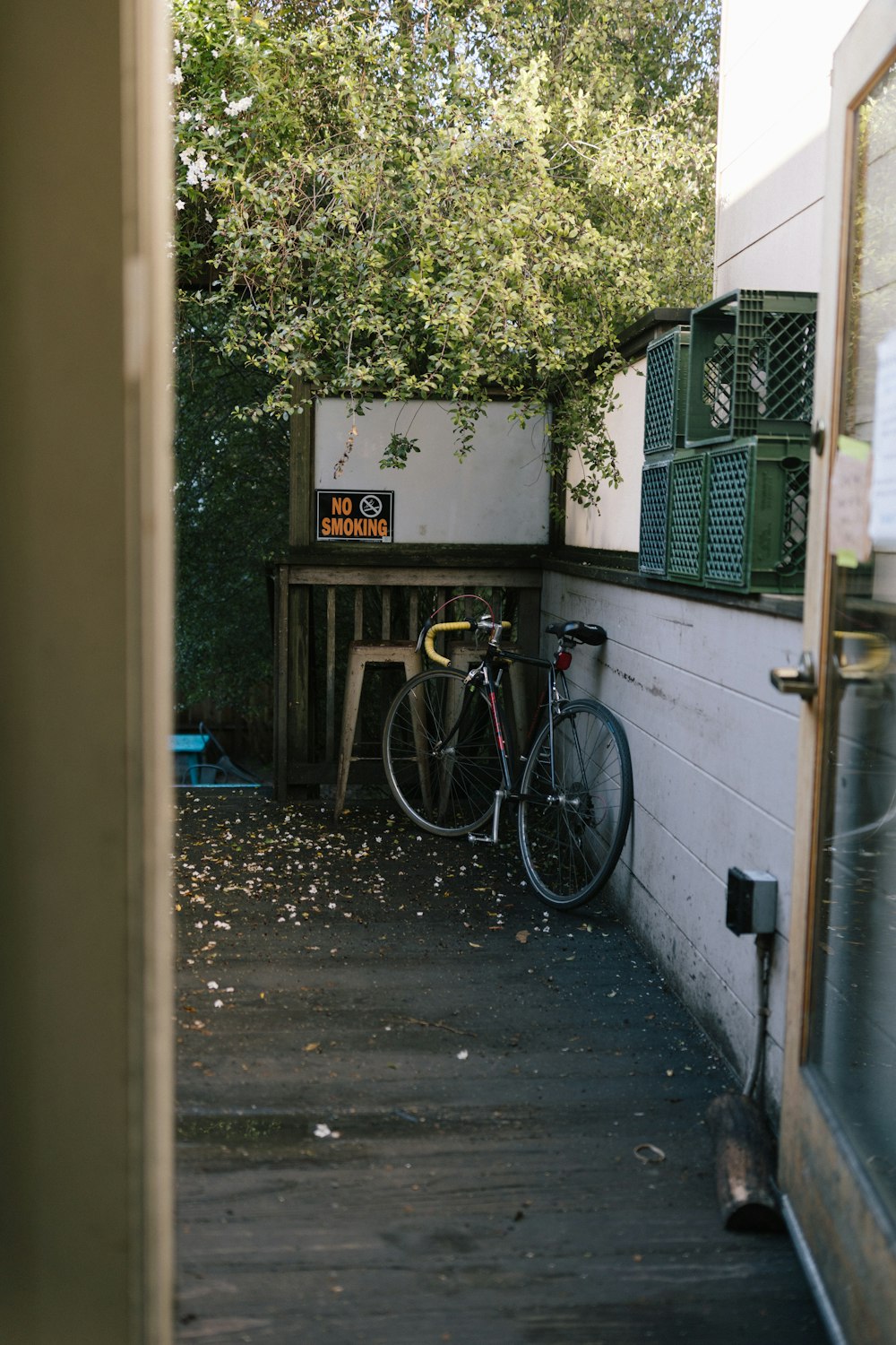 a bicycle parked next to a table on a porch