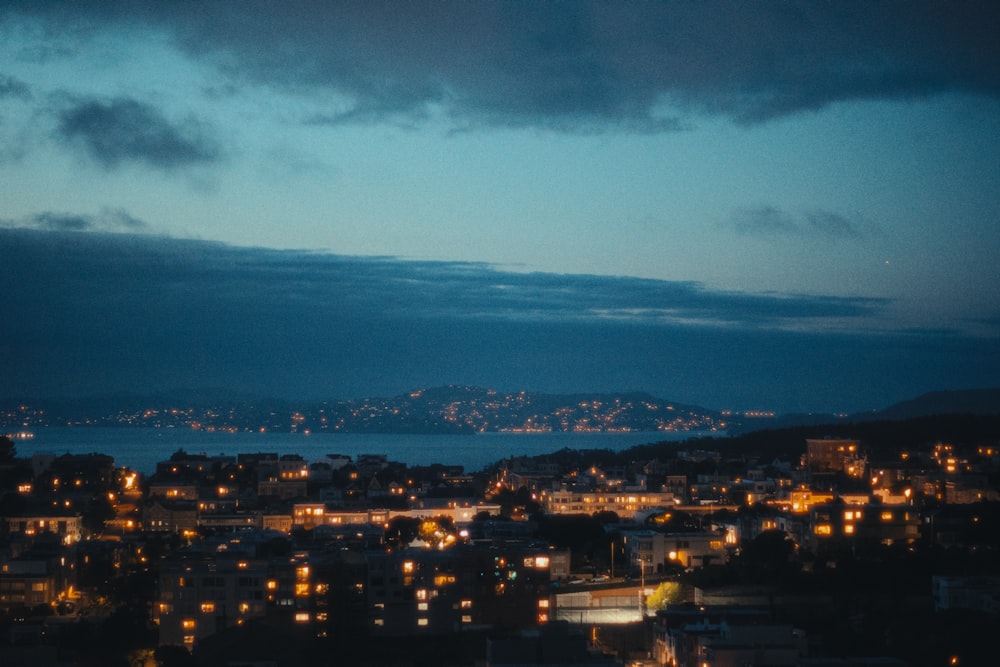 a view of a city at night from a hill