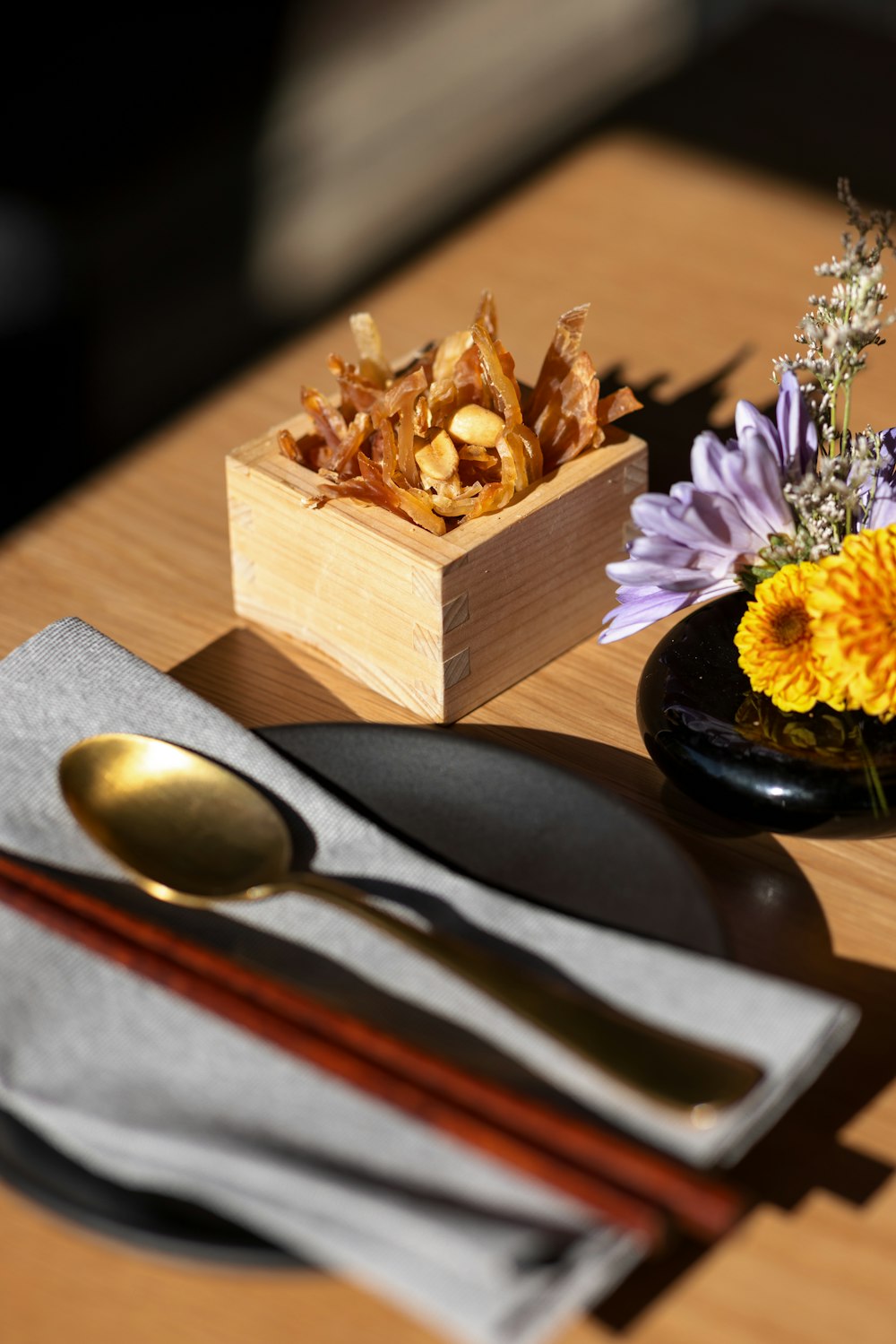 a wooden table topped with a plate of food