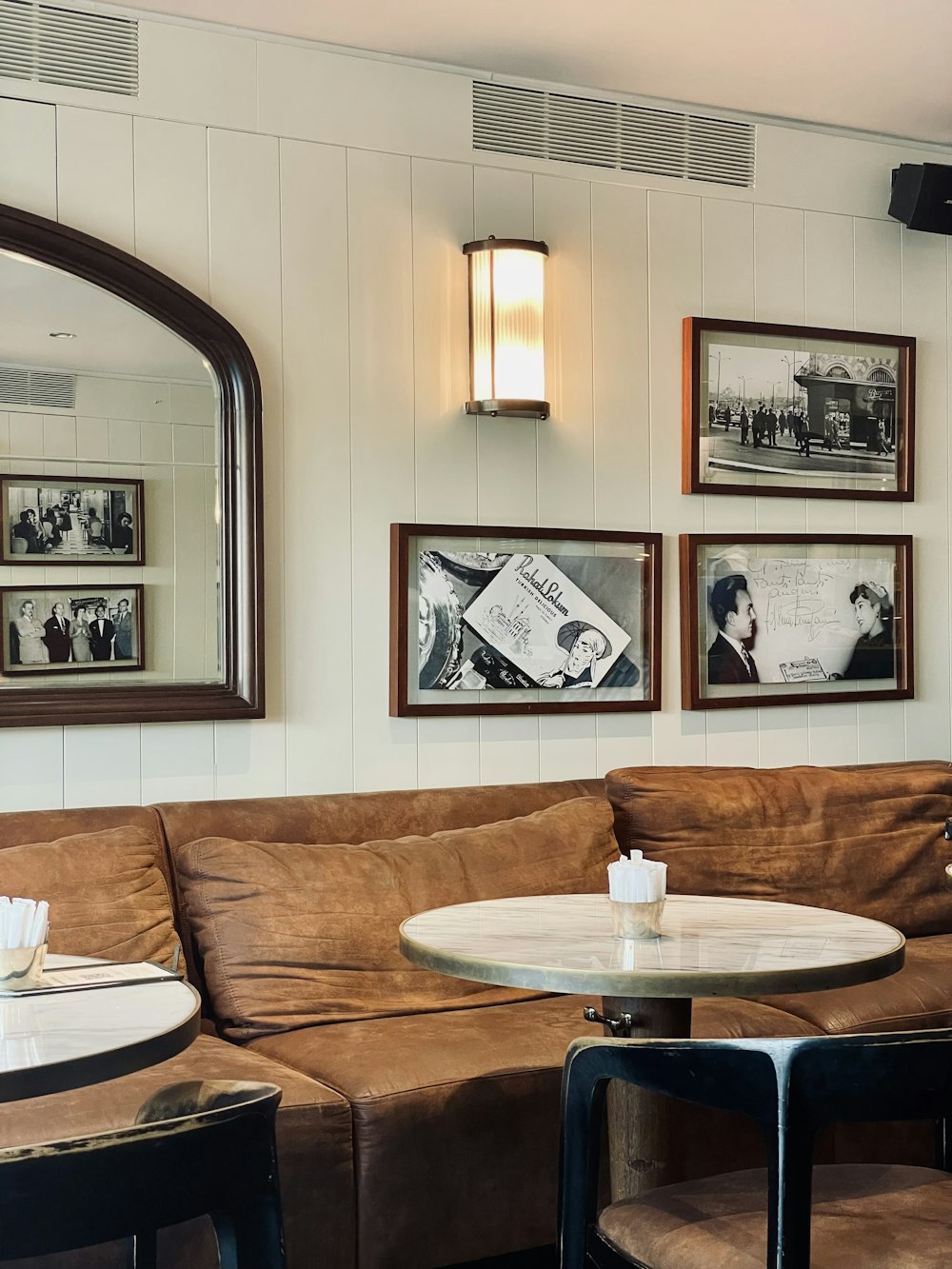 a living room filled with furniture and pictures on the wall