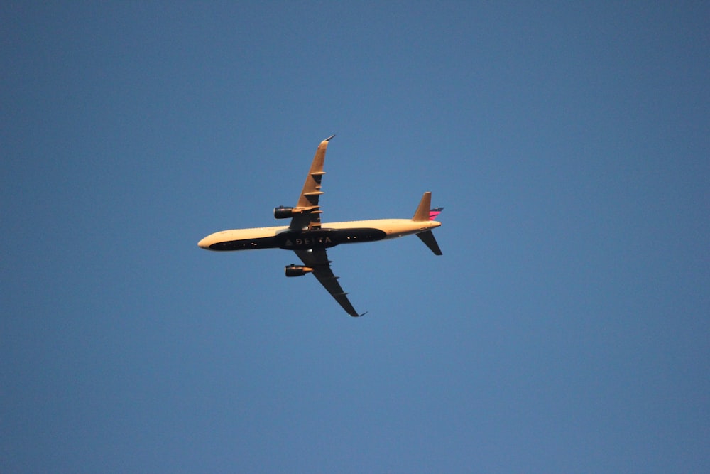 an airplane is flying in the blue sky