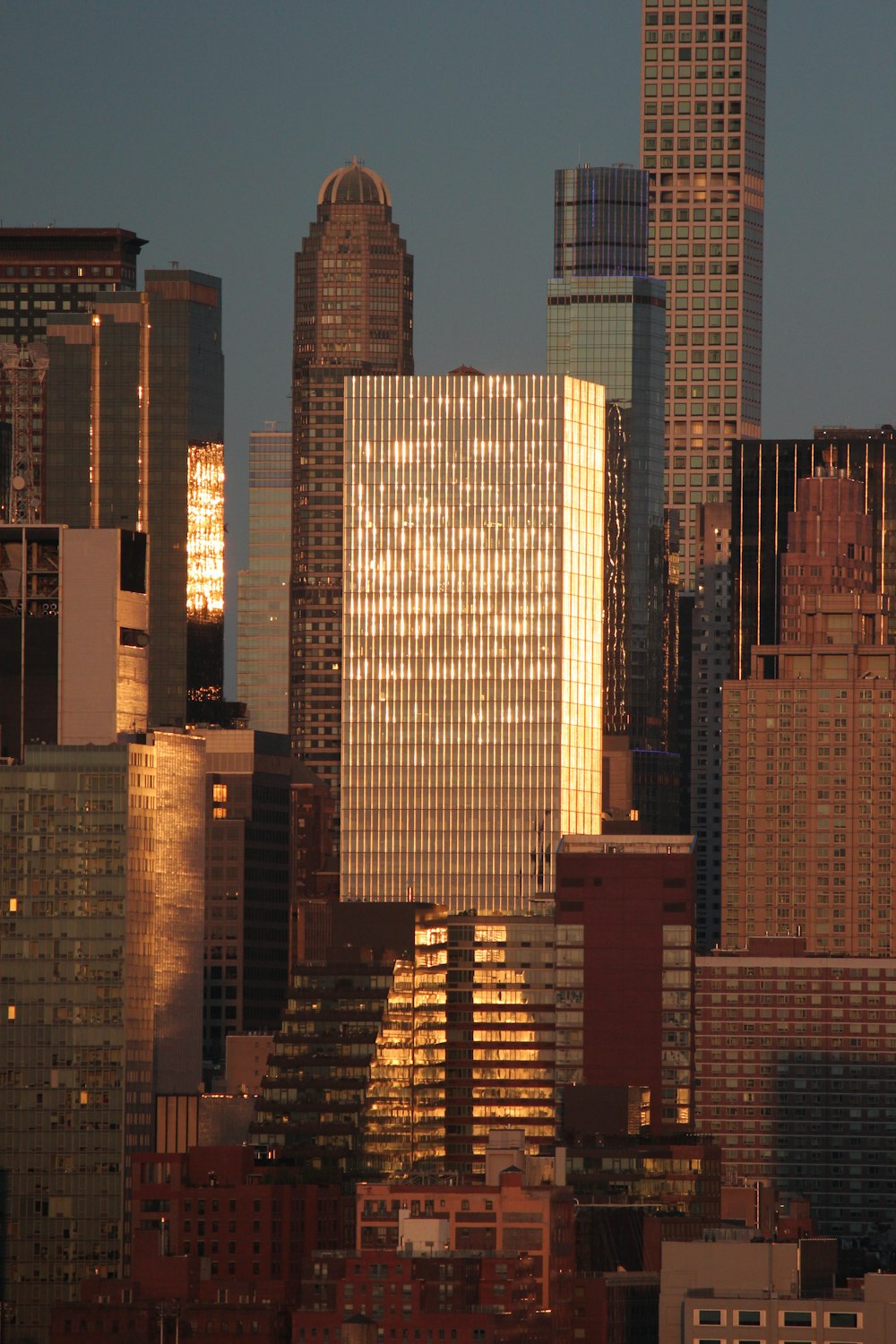 a city skyline with skyscrapers lit up at night