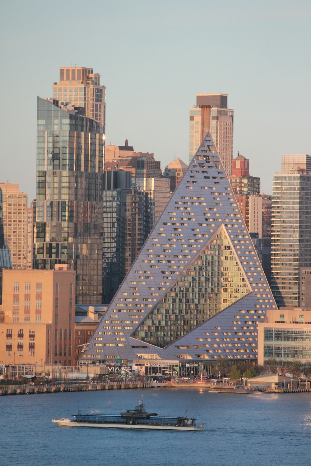 a large triangular shaped building in the middle of a city