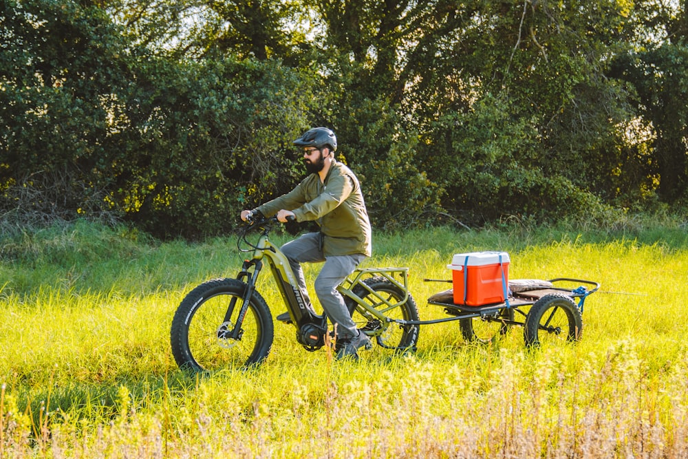 a man riding a bike with a trailer attached to it