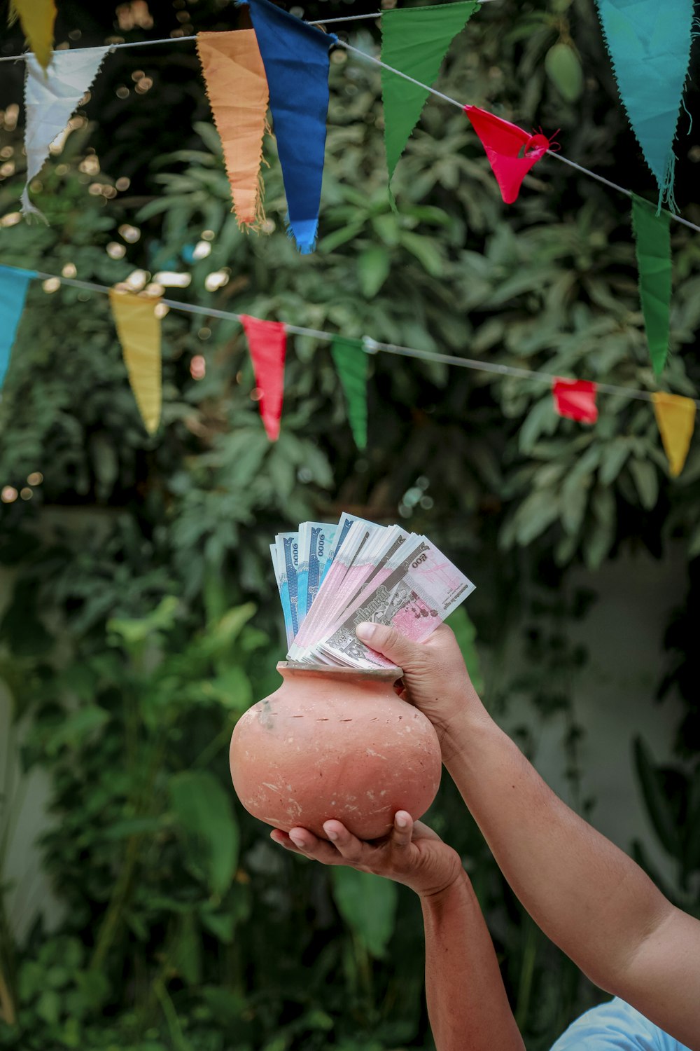 a person holding a ball and money in their hand