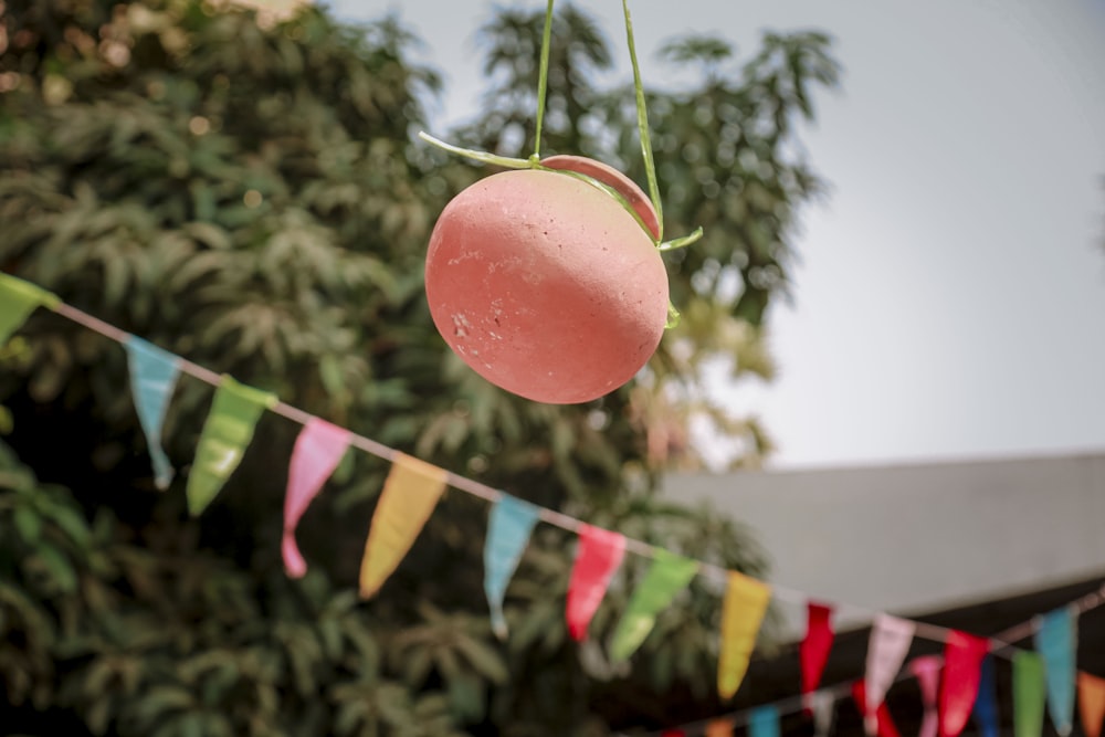 a pink donut hanging from a line of bunting