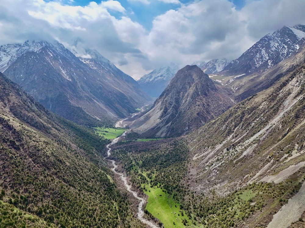 a view of a valley with mountains in the background