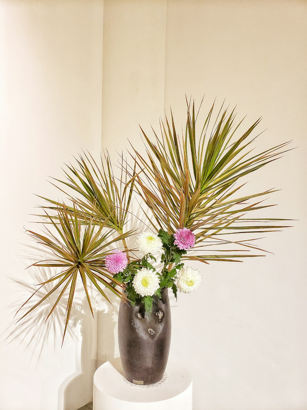 a vase filled with flowers sitting on top of a table