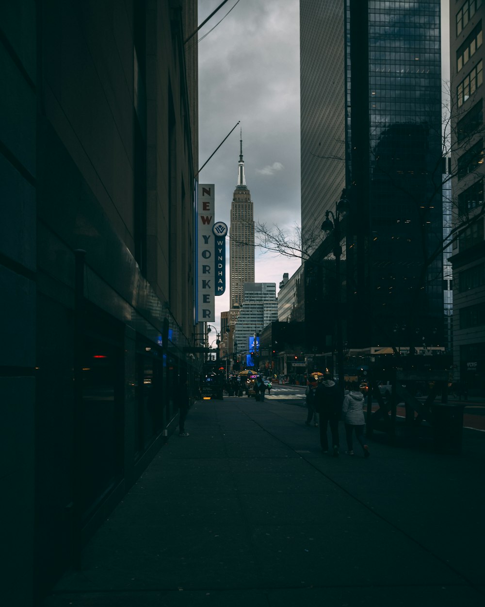 a city street with tall buildings in the background