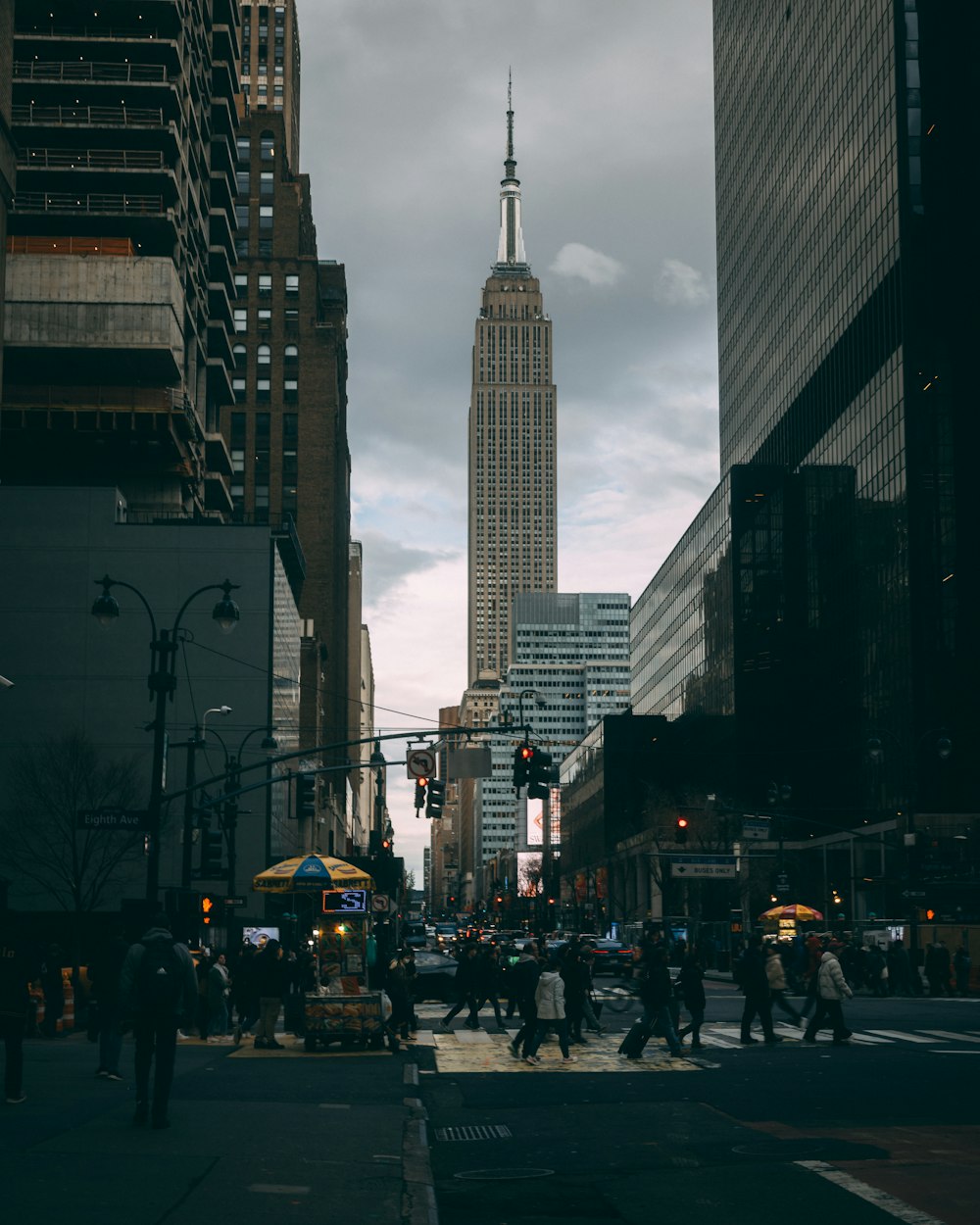 a busy city street with tall buildings in the background