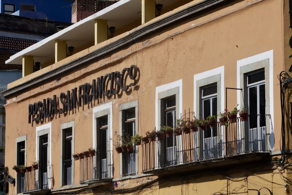 a building with a balcony and a sign on the side of it