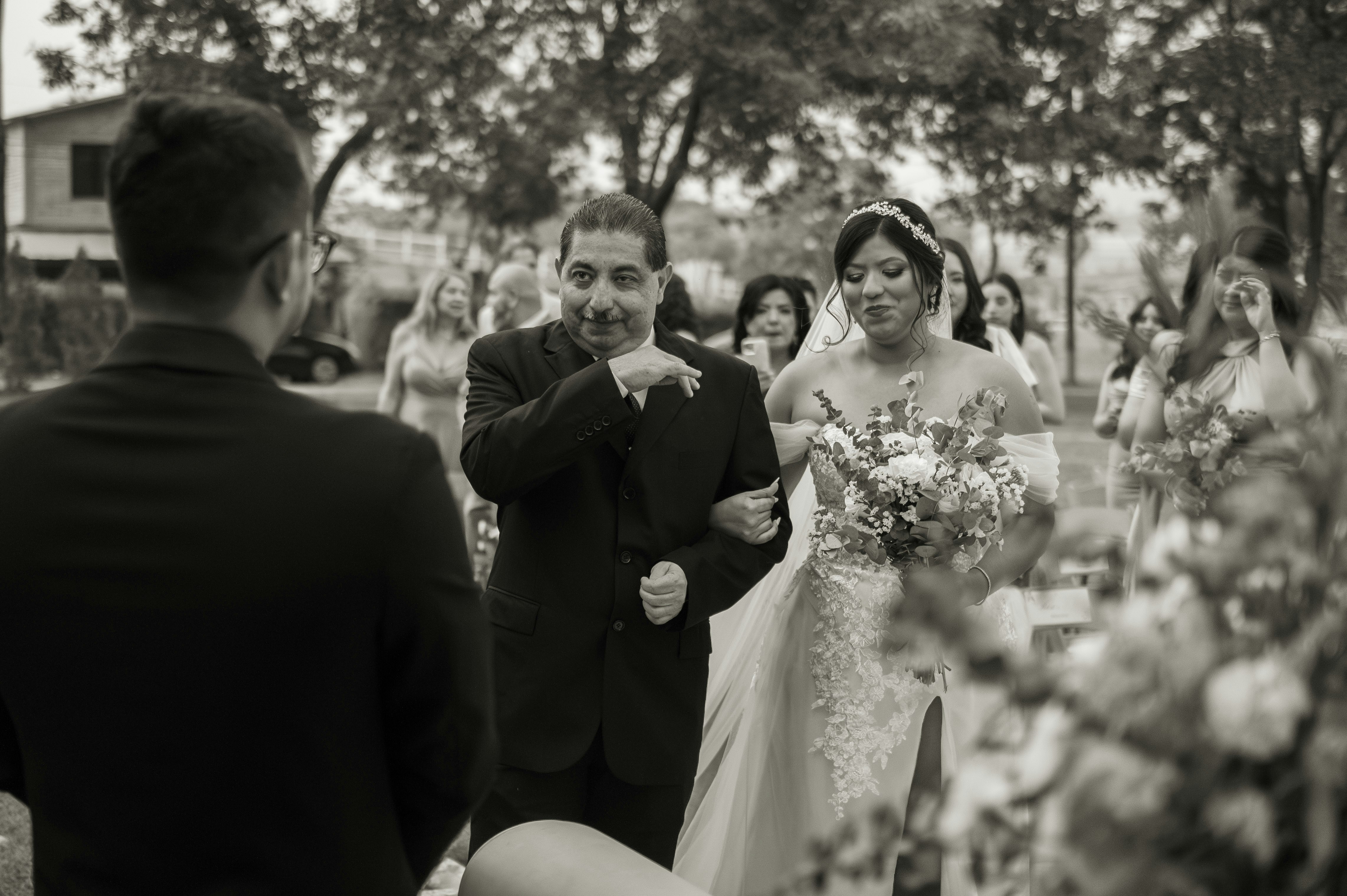 a bride and groom walking down the aisle