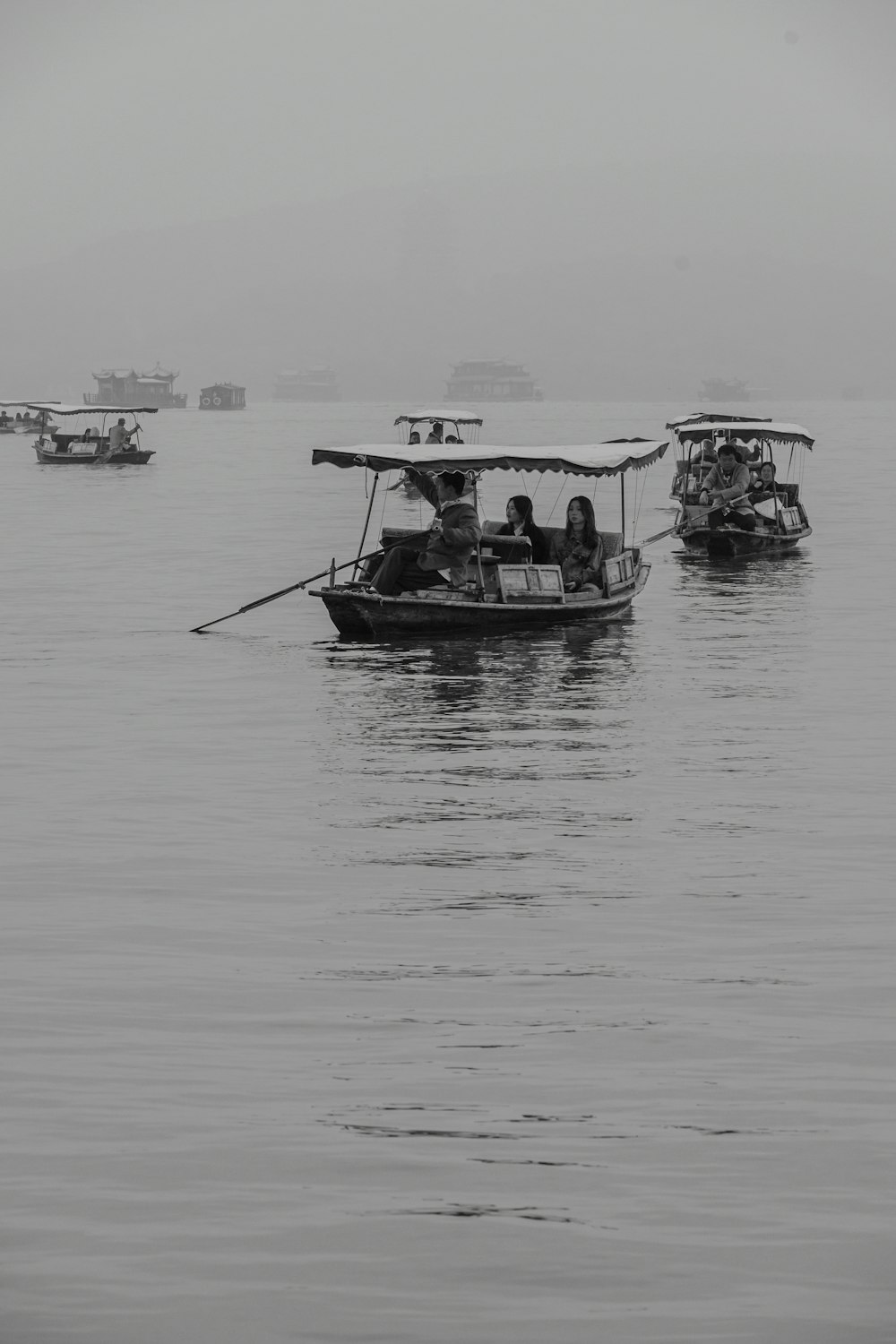 a group of boats floating on top of a large body of water