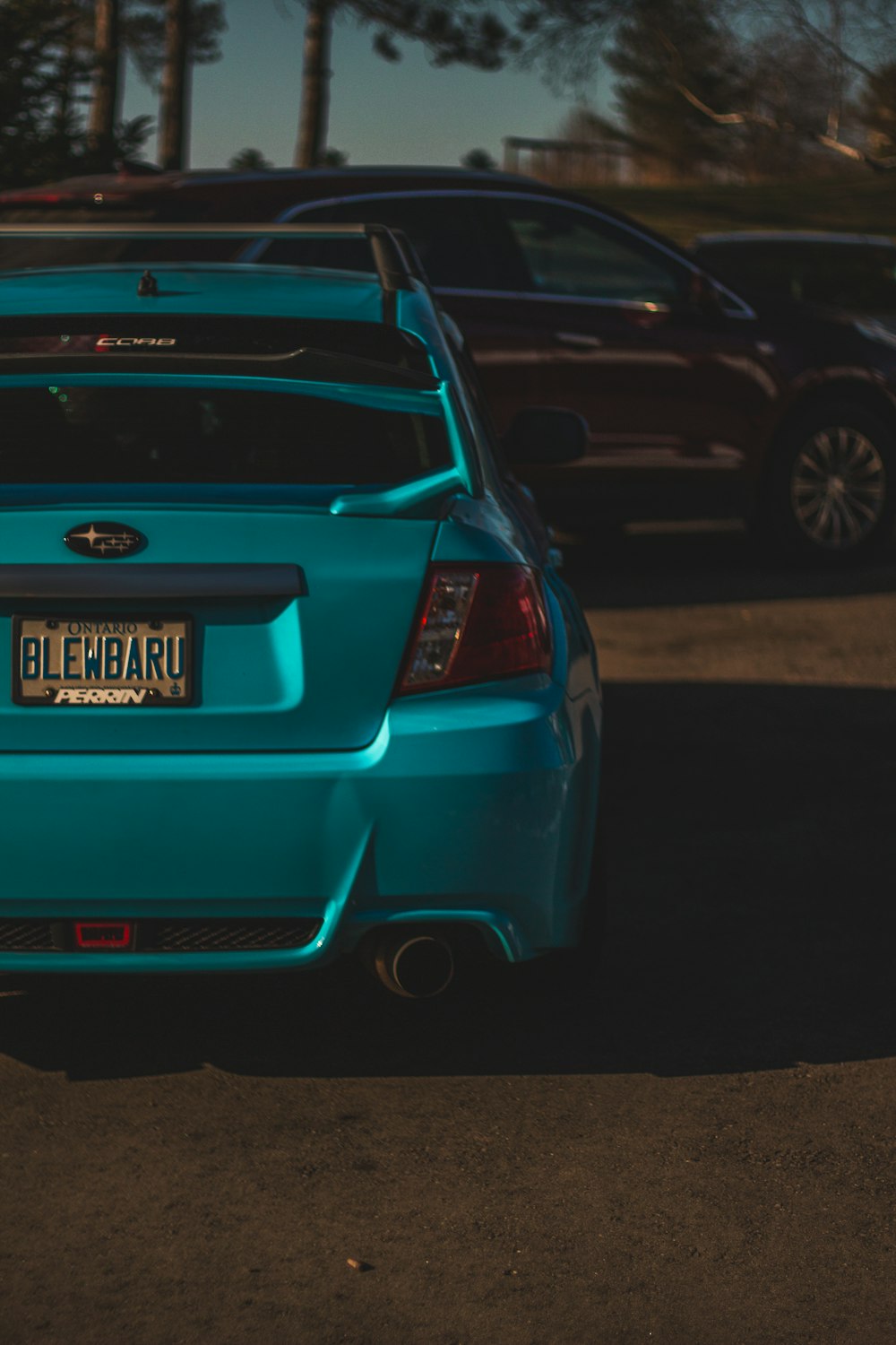 a blue subaru parked in a parking lot