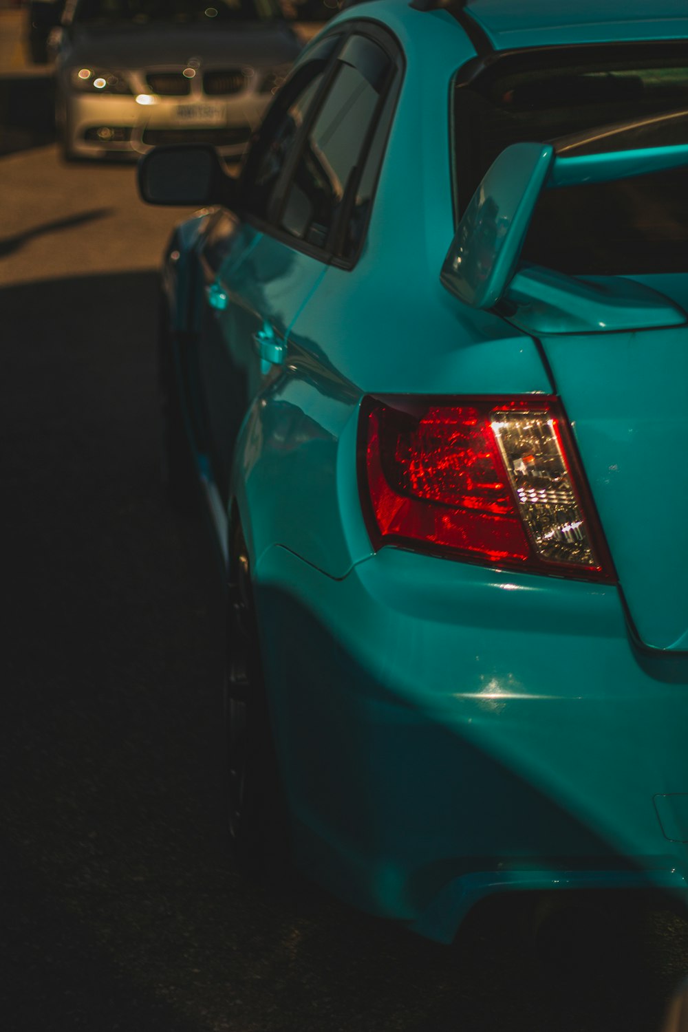 a blue car parked on the side of the road