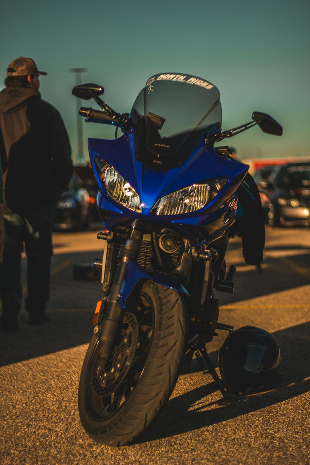 a blue motorcycle parked in a parking lot