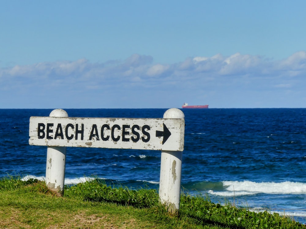 a sign pointing to the beach that says beach access