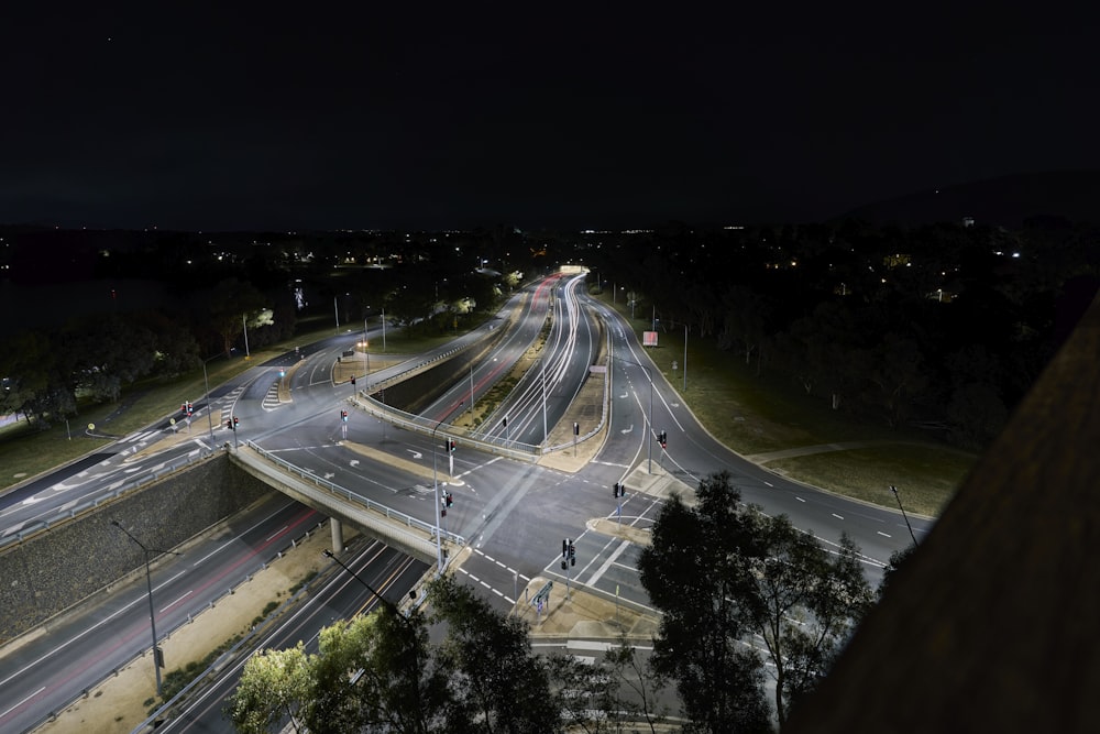 a night time view of a highway intersection