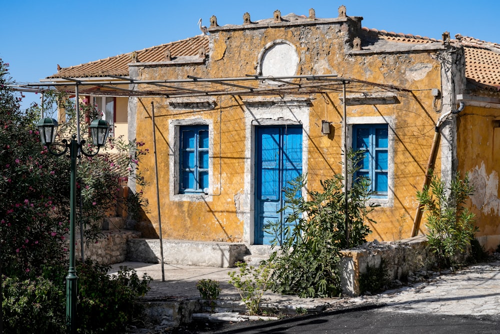 a yellow building with blue doors and windows