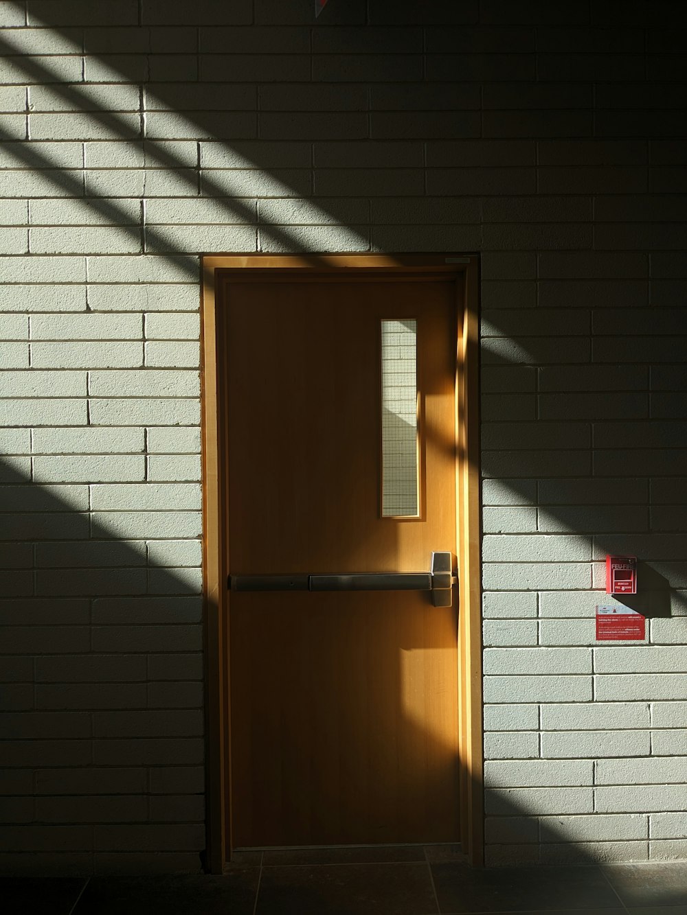 a yellow door with a brick wall in the background