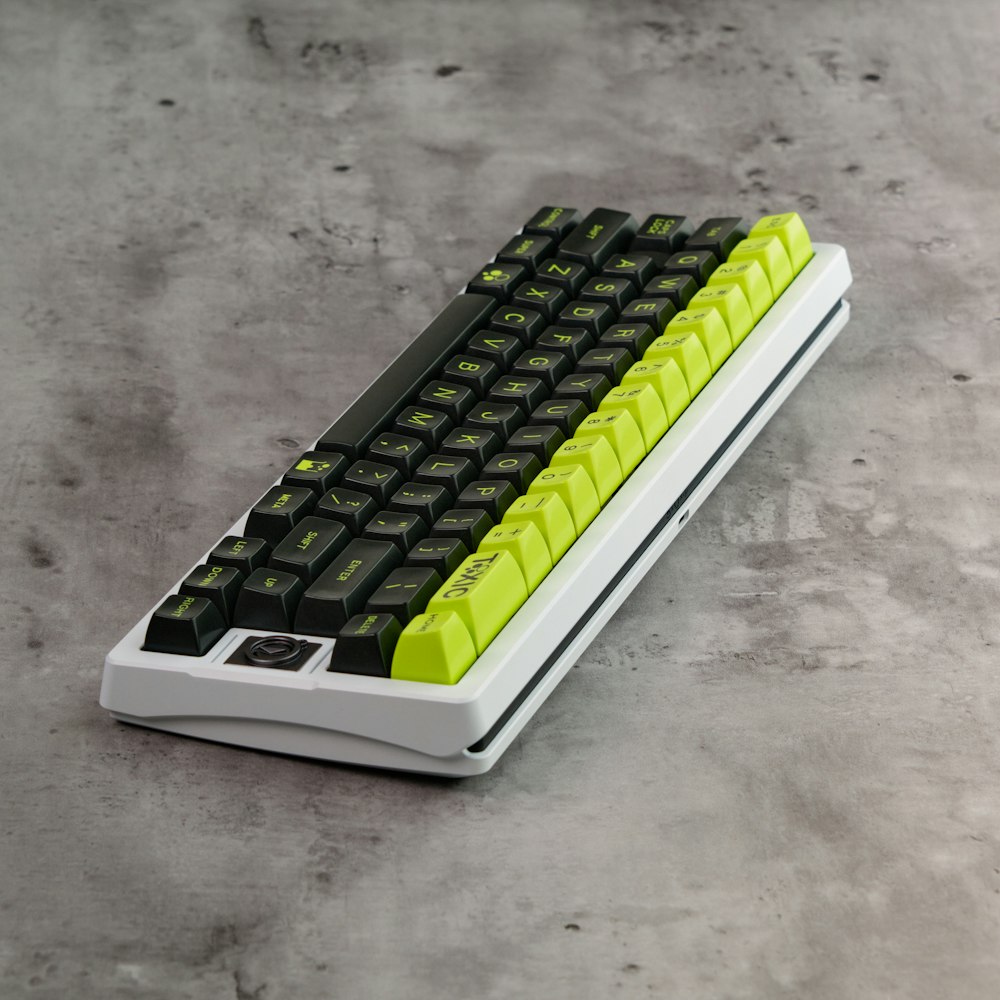 a black and yellow computer keyboard sitting on a table