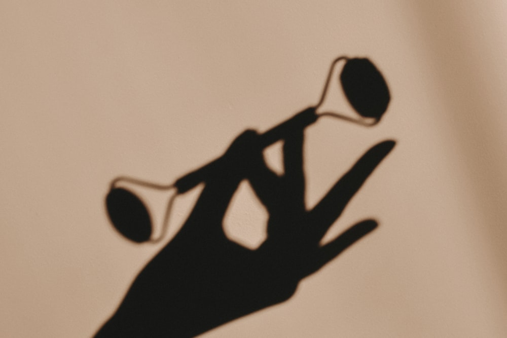 a shadow of a person holding a golf club