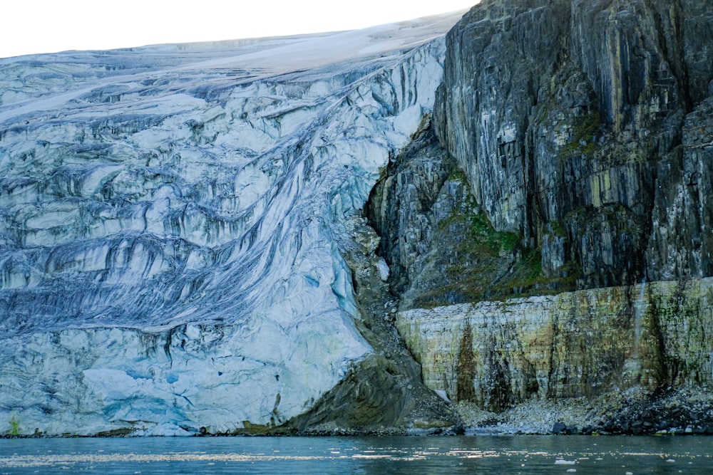 a large glacier with a mountain in the background