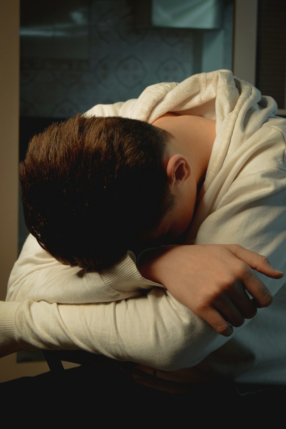 a person with their head resting on a pillow