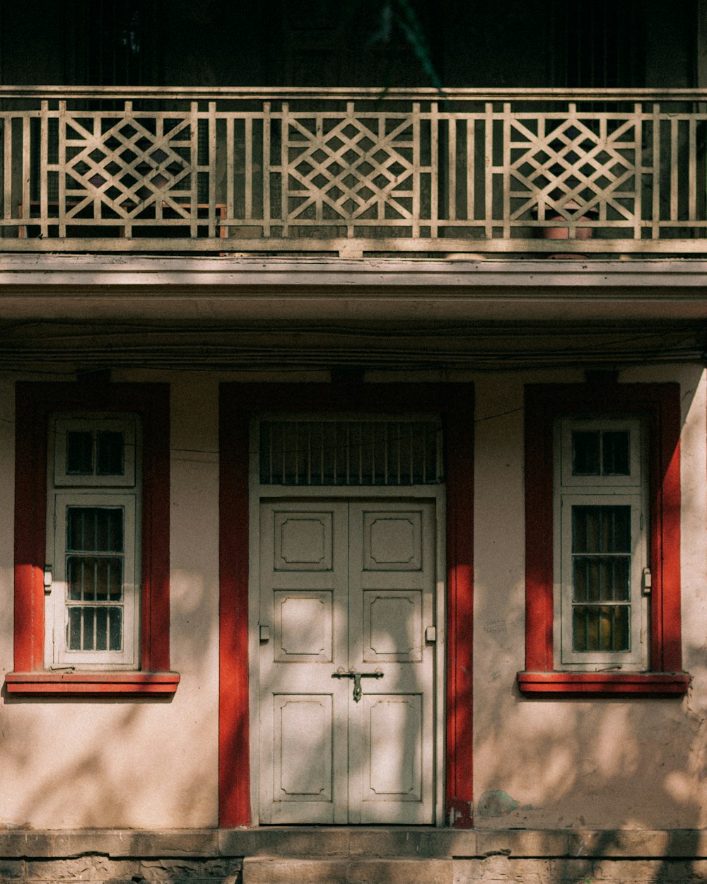 a red and white building with two white doors