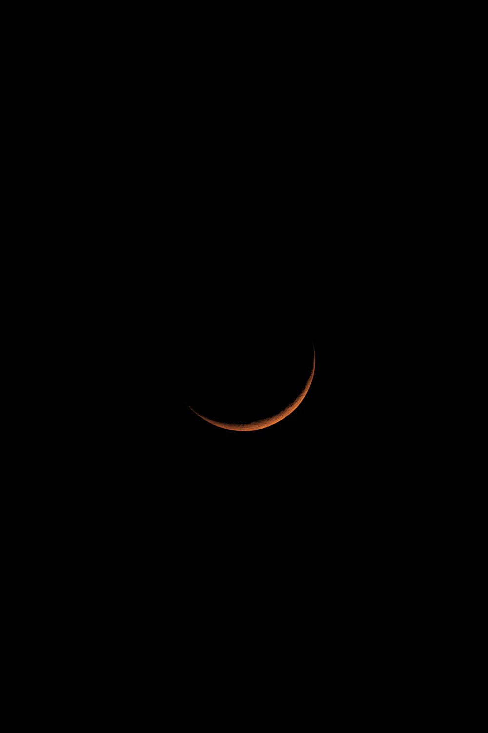 a crescent eclipse in the night sky