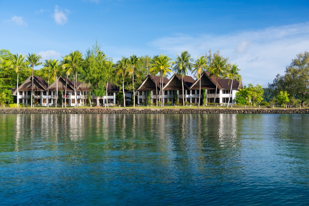 a row of houses sitting on the shore of a lake