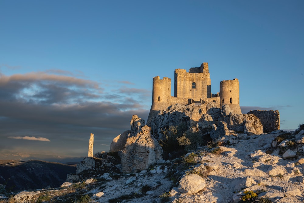 a castle sitting on top of a rocky hill